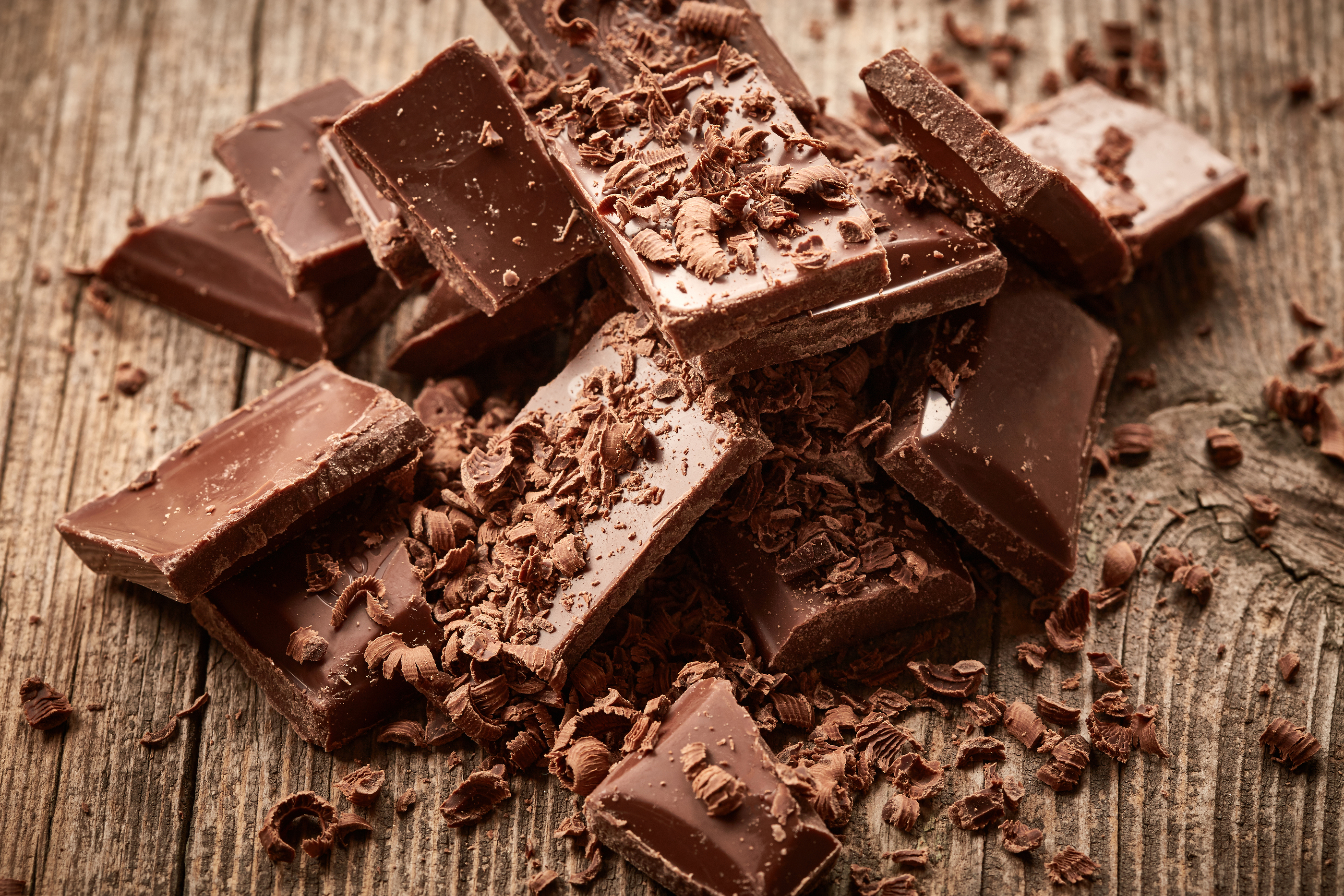 Tasty bar of Chocolate on the wooden background