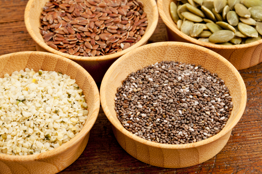 chia, hemp, flax and pumpkin - healthy seeds in small wooden bowls