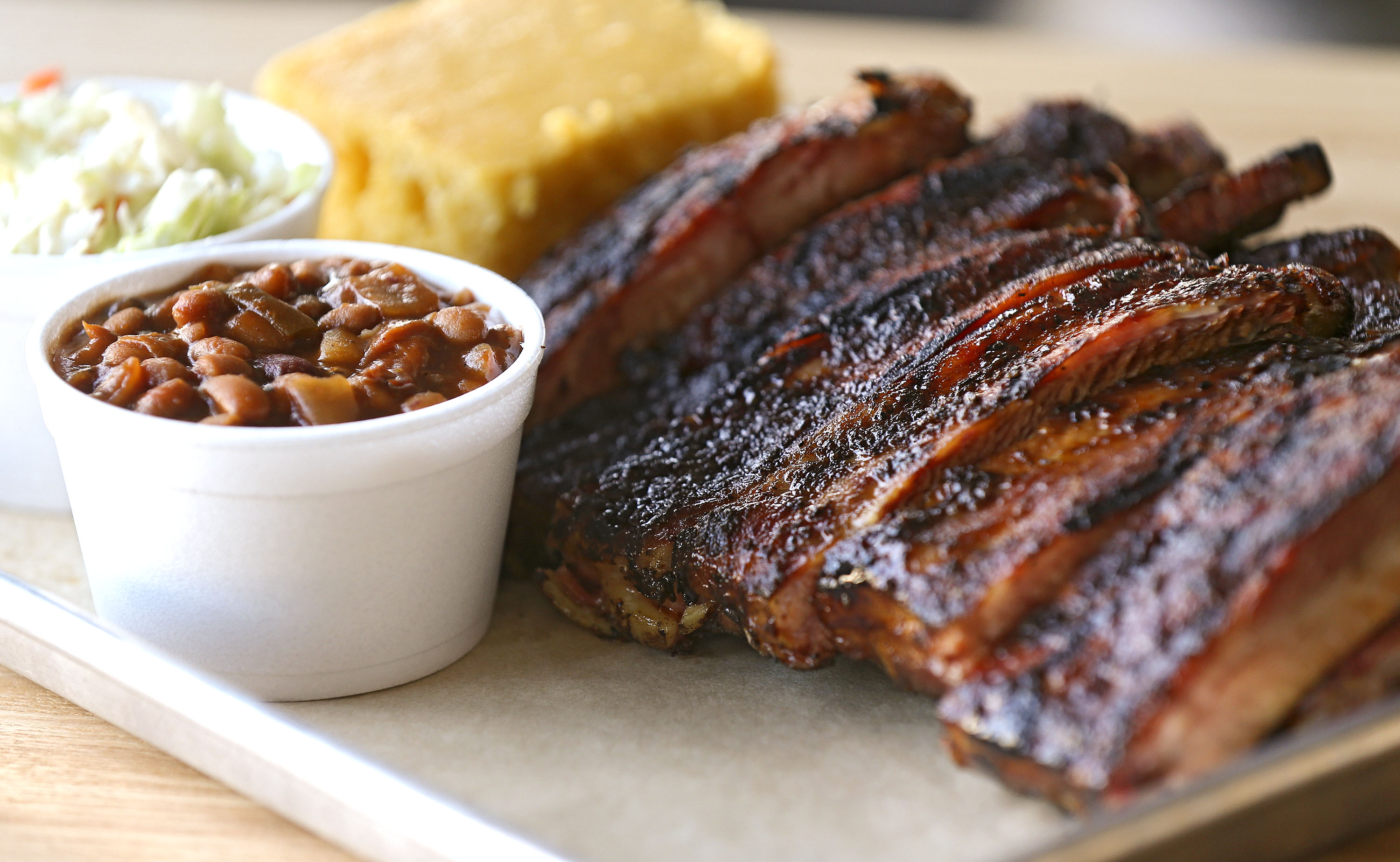 The Full Slab of Ribs meal with coleslaw and baked beans sides and a slice of honey butter corn bread at Jimmy Jack's Rib Shack in Iowa City on Thursday, Oct. 13, 2016. The ribs are St. Louis style pork ribs. (Stephen Mally/The Gazette)